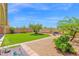 A manicured backyard with artificial grass, seating areas, and desert landscaping for low maintenance appeal at 4611 E Night Glow Dr, Cave Creek, AZ 85331