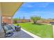 Inviting covered patio and backyard with well-maintained artificial grass and mature desert landscaping at 4611 E Night Glow Dr, Cave Creek, AZ 85331
