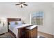 Well-lit bedroom with a wooden bed frame and matching dresser, offering a comfortable space at 4611 E Night Glow Dr, Cave Creek, AZ 85331