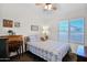 Cozy bedroom with a bed, desk, and large window for natural light at 4611 E Night Glow Dr, Cave Creek, AZ 85331