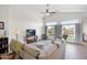 Spacious living room with hardwood floors, comfortable seating, and abundant natural light from the windows at 4611 E Night Glow Dr, Cave Creek, AZ 85331