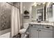 Bathroom featuring modern vanity, granite counters, and shower with elegant patterned tile at 5328 S Wesley Cir, Mesa, AZ 85212