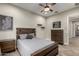 Bedroom featuring modern decor, a comfortable bed, and wooden furniture at 5328 S Wesley Cir, Mesa, AZ 85212