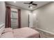 Bedroom showcasing a ceiling fan, window with curtains, and a comfortable bed with pink bedding at 5328 S Wesley Cir, Mesa, AZ 85212