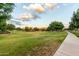 Well-manicured community green space featuring mature trees and inviting walking paths at 5328 S Wesley Cir, Mesa, AZ 85212