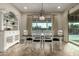 Elegant dining room featuring stylish chandelier and views of the outdoor scenery through large windows at 5328 S Wesley Cir, Mesa, AZ 85212