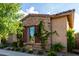 Charming home with stone accents, lush green vines, and verdant landscaping at 5328 S Wesley Cir, Mesa, AZ 85212
