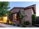 Charming home with stone accents, lush green vines, and verdant landscaping at 5328 S Wesley Cir, Mesa, AZ 85212