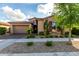 Charming single-Gathering home featuring a stone facade, a two-car garage, and well-maintained landscaping at 5328 S Wesley Cir, Mesa, AZ 85212