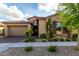 Charming single-Gathering home featuring a stone facade, a two-car garage, and well-maintained landscaping at 5328 S Wesley Cir, Mesa, AZ 85212