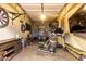 Well-equipped garage featuring a workout area and entertainment setup at 5328 S Wesley Cir, Mesa, AZ 85212