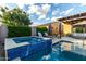 Refreshing hot tub with stone accents, poolside seating, and a covered patio area for outdoor enjoyment at 5328 S Wesley Cir, Mesa, AZ 85212
