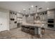 Spacious kitchen featuring grey cabinetry, granite countertops, a large island, and modern appliances at 5328 S Wesley Cir, Mesa, AZ 85212