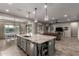 Open-concept kitchen with a large island, stainless steel appliances, and seamless integration with living areas at 5328 S Wesley Cir, Mesa, AZ 85212