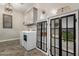 Bright laundry room with wood tile floors, cabinets and washer dryer at 5328 S Wesley Cir, Mesa, AZ 85212