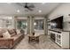 Relaxing living room featuring a cozy sofa, herringbone floors, and large windows with scenic views at 5328 S Wesley Cir, Mesa, AZ 85212