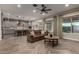 Open-concept living area showcasing herringbone floors, a comfortable sofa, and seamless kitchen access at 5328 S Wesley Cir, Mesa, AZ 85212