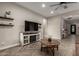 Comfortable living space featuring floating shelves, a decorative fireplace, and stylish herringbone floors at 5328 S Wesley Cir, Mesa, AZ 85212