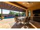 Inviting outdoor patio with a covered dining area, poolside view, and ceiling fan for comfortable entertaining at 5328 S Wesley Cir, Mesa, AZ 85212