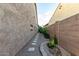 Private side yard with a charming walkway, desert landscaping, and textured stucco walls at 5328 S Wesley Cir, Mesa, AZ 85212