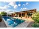 Stunning swimming pool reflecting clear skies and overlooking an outdoor lounge and covered patio at 5328 S Wesley Cir, Mesa, AZ 85212