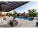 Inviting swimming pool with a lounge area, covered patio, and lush landscaping, perfect for relaxation and entertaining at 5328 S Wesley Cir, Mesa, AZ 85212