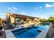 Relaxing backyard showcasing a swimming pool, spa, covered patio, outdoor kitchen, and landscaped garden at 5328 S Wesley Cir, Mesa, AZ 85212