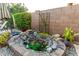Charming backyard water feature with natural stone accents and lush landscaping, creating a serene oasis at 5328 S Wesley Cir, Mesa, AZ 85212