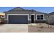 Charming single-Gathering home featuring a two-car garage and stone accents on the facade at 5491 E Mearn Rd, San Tan Valley, AZ 85140