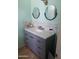 Bathroom with a marble-topped vanity and a pair of round mirrors at 5539 N 31St Ln, Phoenix, AZ 85017