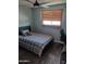 Cozy bedroom features a plaid comforter, window blinds, and a ceiling fan for added comfort at 5539 N 31St Ln, Phoenix, AZ 85017