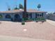 Stylish single-story home featuring a stucco exterior, desert landscaping, and mature palm trees at 5539 N 31St Ln, Phoenix, AZ 85017