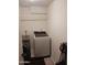 Functional laundry room with modern appliances, including a front-load washer and dryer, and shelving at 5539 N 31St Ln, Phoenix, AZ 85017