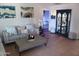Cozy living room featuring neutral-toned furniture, decorative wall art, and tile flooring at 5539 N 31St Ln, Phoenix, AZ 85017
