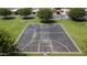 Aerial view of the blacktop basketball court with green grassy surrounding in a neighborhood at 5601 W Missouri Ave # 150, Glendale, AZ 85301