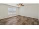 A bedroom with a ceiling fan and neutral-colored vinyl flooring at 5601 W Missouri Ave # 150, Glendale, AZ 85301