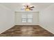 A bright, modern bedroom featuring wood look floors, a ceiling fan and neutral walls at 5601 W Missouri Ave # 150, Glendale, AZ 85301