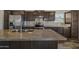 Close-up of kitchen island with stainless appliances and fixtures against white tiled backsplash at 5601 W Missouri Ave # 150, Glendale, AZ 85301