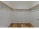 Walk-in closet with a wood floor and clothes bar at 5601 W Missouri Ave # 150, Glendale, AZ 85301