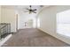 Bright and airy bedroom with a ceiling fan, neutral carpeting, and a view of the loft area at 5749 S 21St Ter, Phoenix, AZ 85040