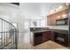 Open-concept kitchen features modern appliances, granite counters, and a view of the living room at 5749 S 21St Ter, Phoenix, AZ 85040