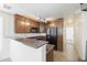 Cozy kitchen features wooden cabinets, granite countertops, black appliances, and a convenient breakfast bar at 5749 S 21St Ter, Phoenix, AZ 85040