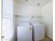 Functional laundry room with washer, dryer, shelving and natural light at 5749 S 21St Ter, Phoenix, AZ 85040