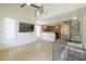 Bright living room features tile floors, a spiral staircase, and an open layout connecting to the kitchen at 5749 S 21St Ter, Phoenix, AZ 85040
