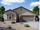 Charming single-story home with neutral stucco exterior, two-car garage, and low-maintenance desert landscaping at 5832 W Coplen Farms Rd, Laveen, AZ 85339