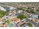 This aerial view showcases the neighborhood with houses that have pools, solar panels, and RV parking at 608 E Arabian Ct, Gilbert, AZ 85296