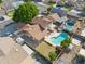 An aerial view showcasing the home with a backyard pool, patio, and well-maintained landscaping at 608 E Arabian Ct, Gilbert, AZ 85296