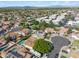 This aerial showcases the neighborhood, and a house with solar panels and a private pool at 608 E Arabian Ct, Gilbert, AZ 85296