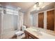 Traditional bathroom featuring a bath tub with shower and vanity with mirror and lighting at 608 E Arabian Ct, Gilbert, AZ 85296