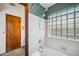 Updated bathroom with a shower and glass block window providing natural light and privacy at 608 E Arabian Ct, Gilbert, AZ 85296